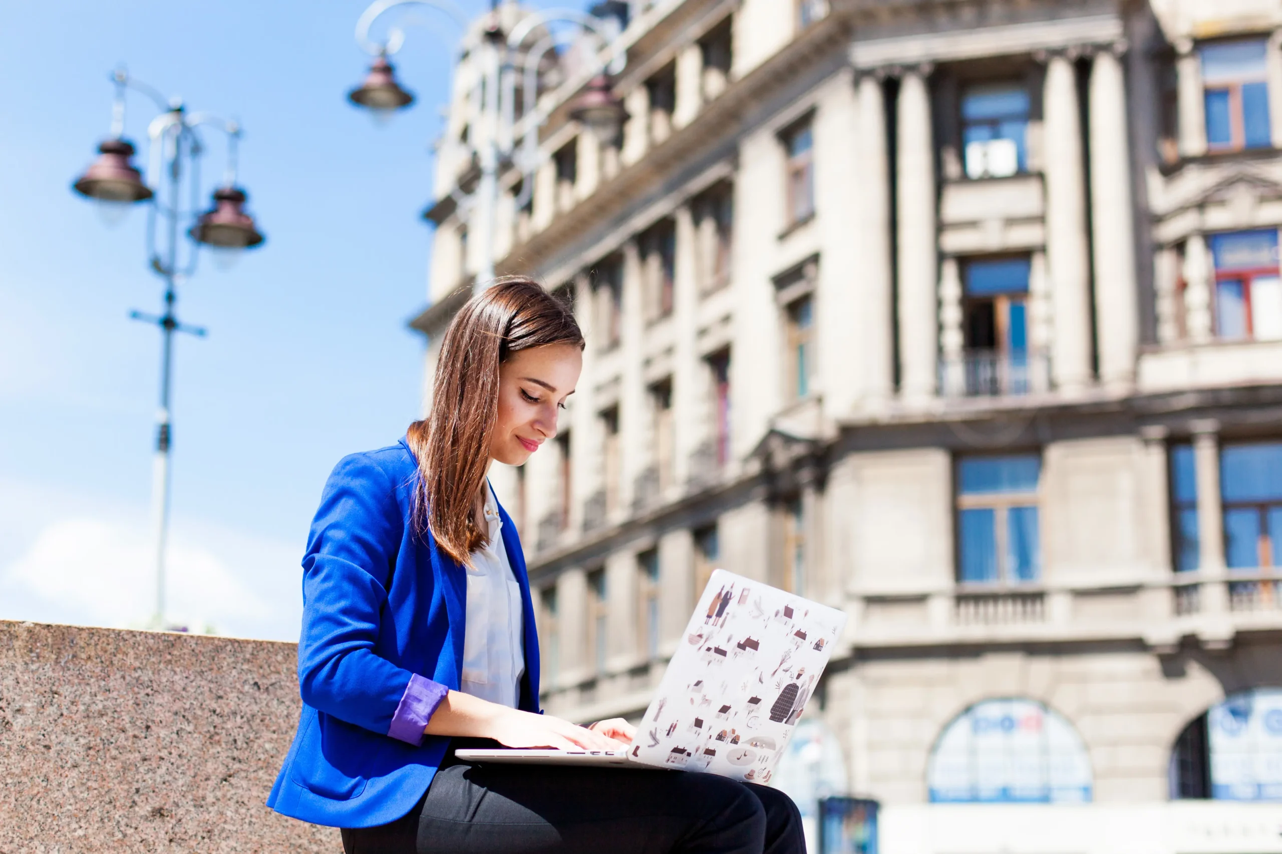 woman-sits-street-works-with-laptop